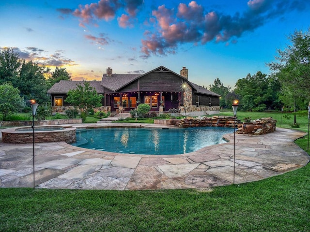 123 County Rd, Paige, TX 78659 - view of swimming pool with a patio area, a lawn, and a pool with connected hot tub