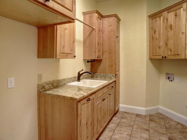 123 County Rd, Paige, TX 78659 - laundry area featuring cabinet space, hookup for a washing machine, baseboards, and light tile patterned floors