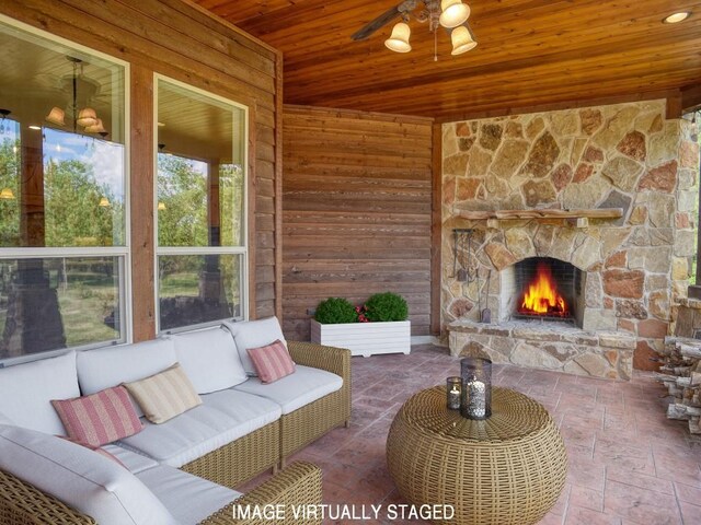 123 County Rd, Paige, TX 78659 - living area featuring wood ceiling, wood walls, an outdoor stone fireplace, and ceiling fan