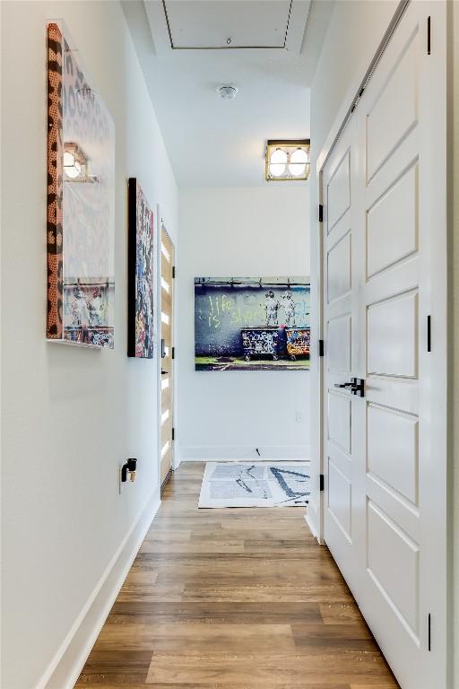 8603 Big Horn Cir, Lago Vista, TX 78645 - hallway featuring attic access and light wood-type flooring