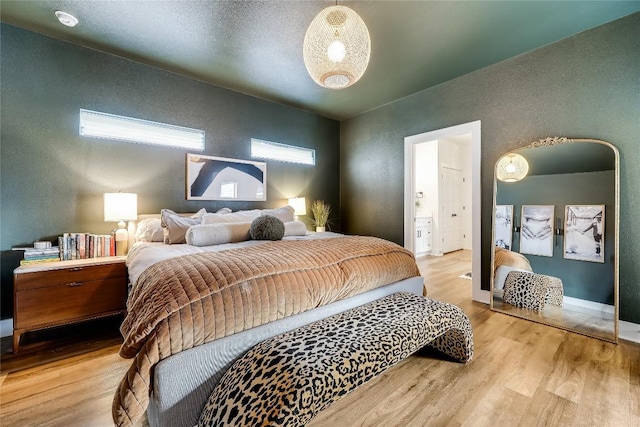 8603 Big Horn Cir, Lago Vista, TX 78645 - bedroom featuring wood finished floors and a textured wall