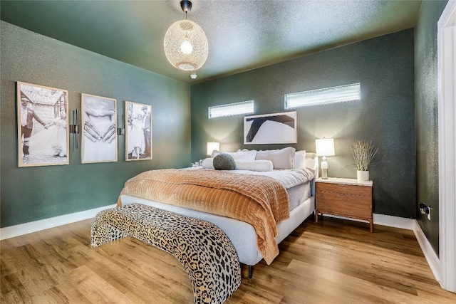8603 Big Horn Cir, Lago Vista, TX 78645 - bedroom with wood finished floors and a textured wall
