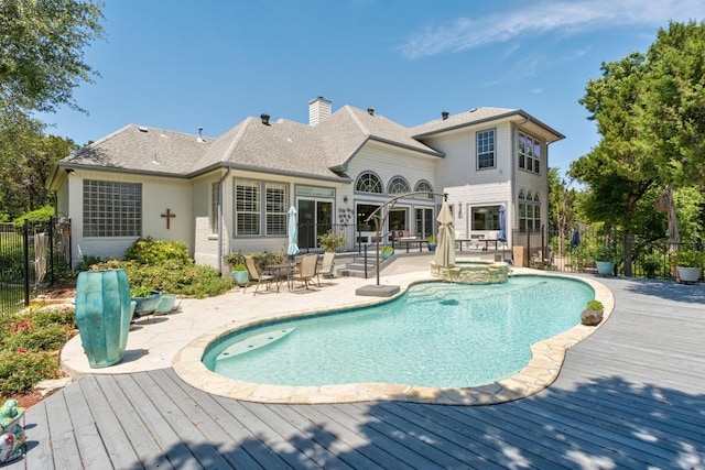 9201 Silver Pine Cv, Austin, TX 78733 - back of property featuring a wooden deck, fence, a patio area, and a chimney