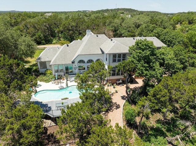 9201 Silver Pine Cv, Austin, TX 78733 - view from above of property with a heavily wooded area and a pool