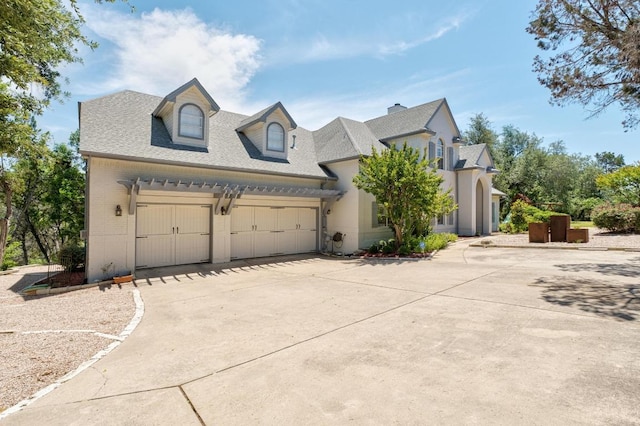 9201 Silver Pine Cv, Austin, TX 78733 - view of front of home featuring driveway, an attached garage, roof with shingles, and brick siding
