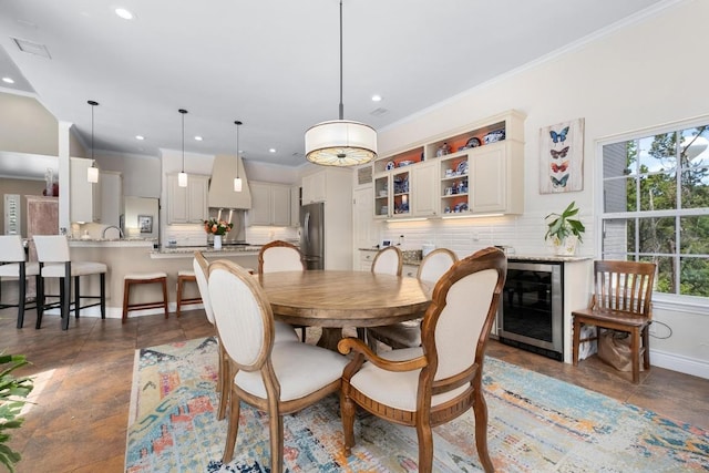 9201 Silver Pine Cv, Austin, TX 78733 - dining area with beverage cooler, crown molding, recessed lighting, and baseboards