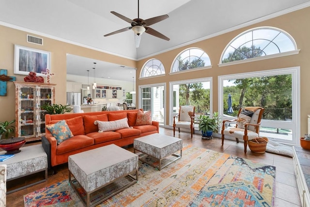9201 Silver Pine Cv, Austin, TX 78733 - tiled living room featuring ceiling fan, a high ceiling, and crown molding
