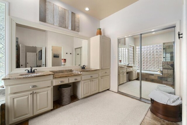 9201 Silver Pine Cv, Austin, TX 78733 - full bathroom with tiled shower and double vanity