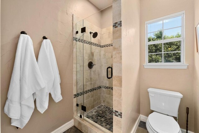 9201 Silver Pine Cv, Austin, TX 78733 - full bathroom with a shower stall, baseboards, and toilet
