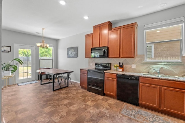 806 Sawbuck Dr, Pflugerville, TX 78660 - kitchen featuring black appliances, tasteful backsplash, brown cabinetry, a chandelier, and recessed lighting
