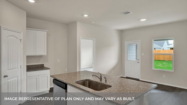 kitchen with a sink, stainless steel dishwasher, light stone countertops, white cabinetry, and dark wood-type flooring