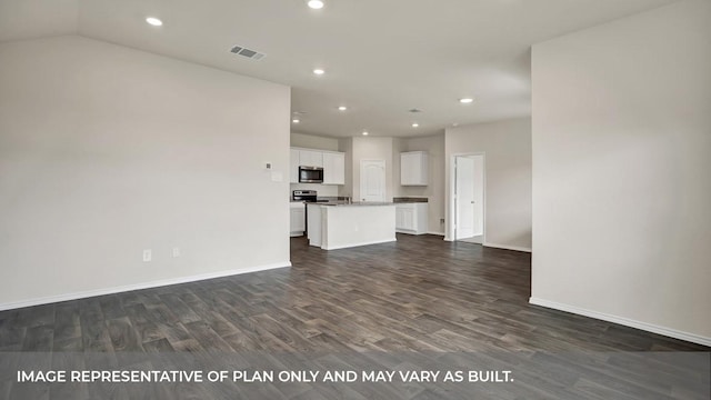 unfurnished living room featuring dark wood finished floors, recessed lighting, and baseboards