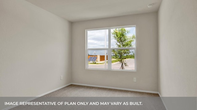 carpeted empty room featuring healthy amount of natural light and baseboards