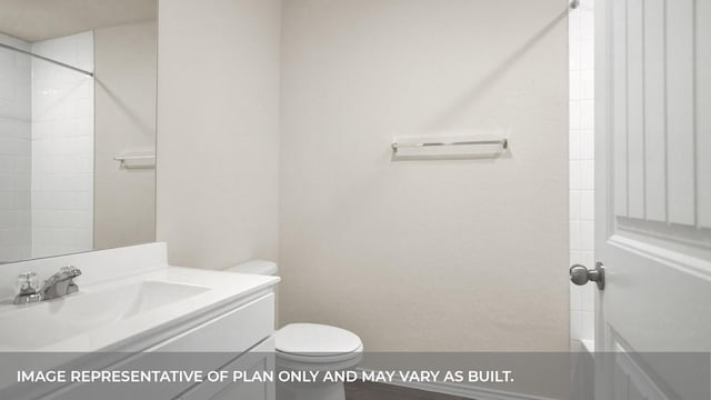 bathroom with vanity, toilet, and a shower