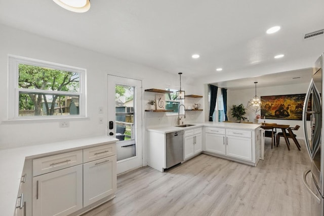 8805 Ravello Pass, Austin, TX 78749 - kitchen featuring stainless steel appliances, a sink, open shelves, light wood-style floors, and recessed lighting