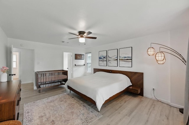 8805 Ravello Pass, Austin, TX 78749 - bedroom with light wood finished floors, multiple windows, and baseboards