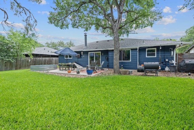 rear view of property with a patio area, heating fuel, a hot tub, and a shingled roof