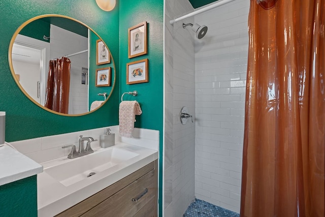 2612 Baxter Dr, Austin, TX 78745 - bathroom featuring vanity, a tile shower, and a textured wall