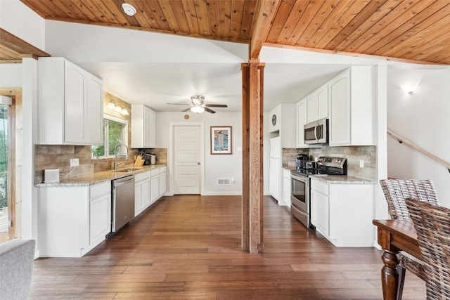 913 Lake Shore Dr, Spicewood, TX 78669 - kitchen featuring appliances with stainless steel finishes, ceiling fan, wooden ceiling, decorative backsplash, and a sink