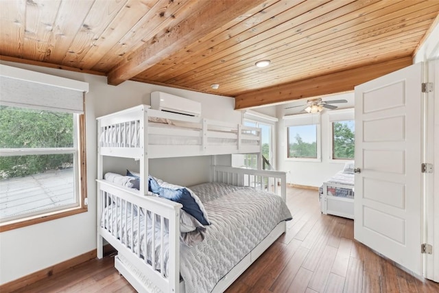 913 Lake Shore Dr, Spicewood, TX 78669 - bedroom with a wall mounted air conditioner, wood ceiling, multiple windows, baseboards, and wood finished floors