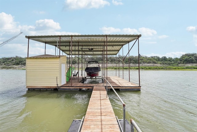 dock area featuring boat lift and a water view