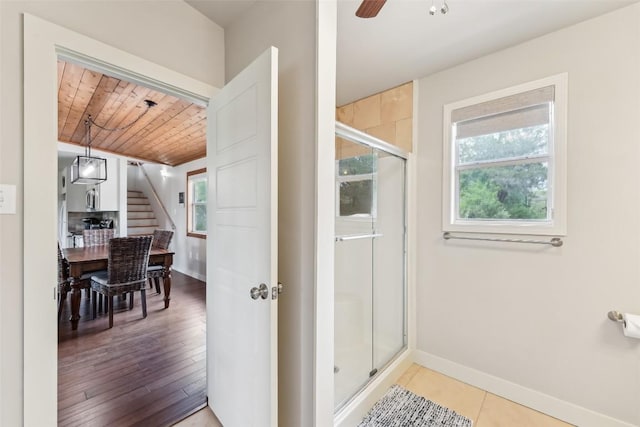 full bath with wooden ceiling, a shower stall, baseboards, and ceiling fan