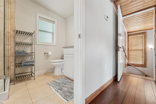 913 Lake Shore Dr, Spicewood, TX 78669 - full bathroom featuring toilet, a stall shower, baseboards, vanity, and tile patterned flooring