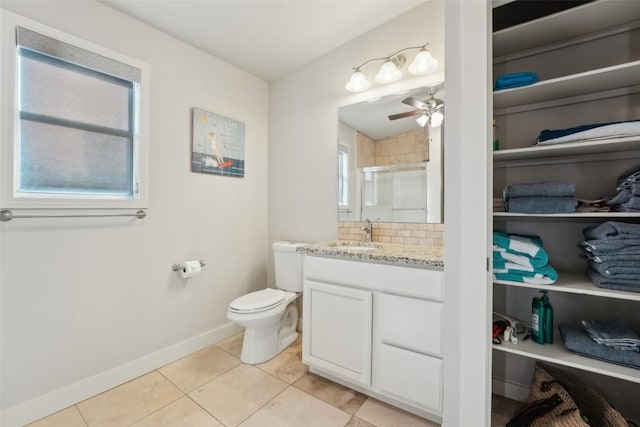 913 Lake Shore Dr, Spicewood, TX 78669 - full bath with a stall shower, vanity, baseboards, tile patterned flooring, and ceiling fan