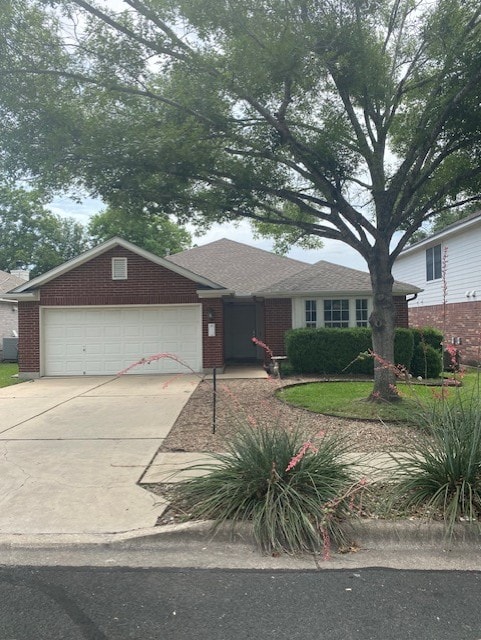 view of front facade featuring a garage, concrete driveway, and brick siding