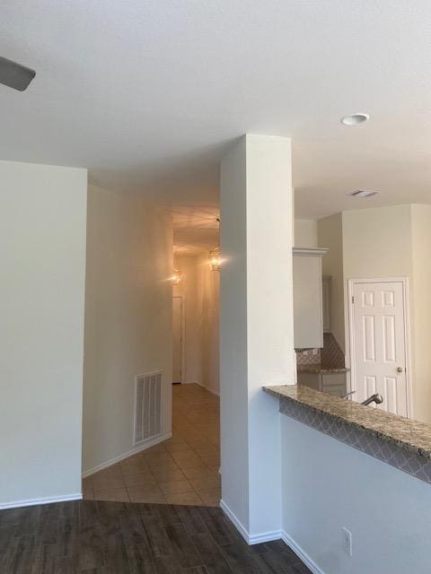 spare room with wood finished floors, recessed lighting, and baseboards