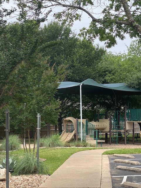 view of home's community featuring fence and uncovered parking