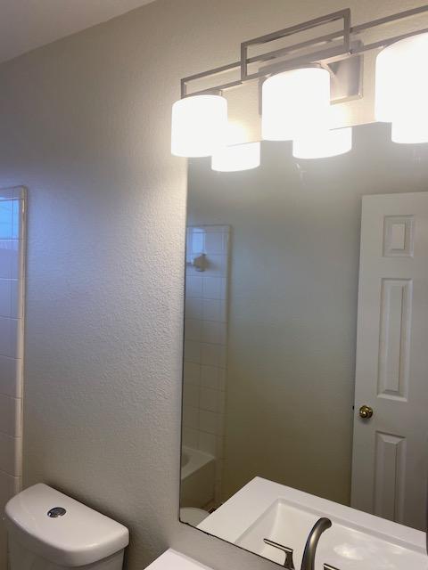 full bathroom featuring toilet and a shower