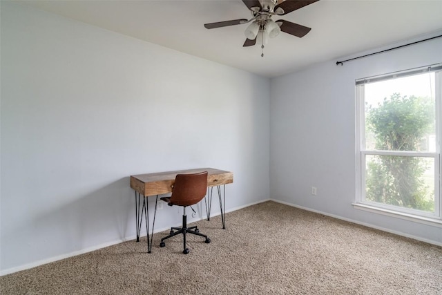 unfurnished office with carpet flooring, a ceiling fan, and baseboards