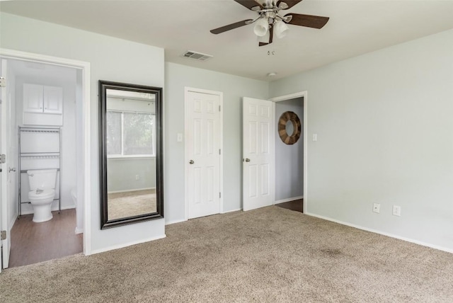 unfurnished bedroom featuring carpet flooring, baseboards, and ensuite bath