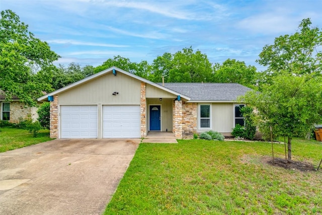 view of front facade featuring a garage, concrete driveway, a front yard, and a shingled roof