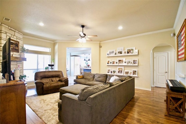 2502 Joseph Dr, Copperas Cove, TX 76522 - living area featuring dark wood-style floors, arched walkways, a ceiling fan, crown molding, and recessed lighting