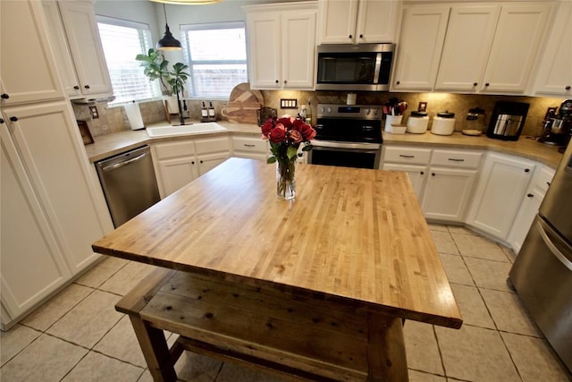 2502 Joseph Dr, Copperas Cove, TX 76522 - kitchen with appliances with stainless steel finishes, a sink, light tile patterned floors, and wooden counters