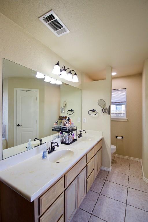 2502 Joseph Dr, Copperas Cove, TX 76522 - bathroom featuring toilet, tile patterned flooring, double vanity, and baseboards