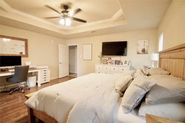 2502 Joseph Dr, Copperas Cove, TX 76522 - bedroom featuring a raised ceiling, wood finished floors, a desk, crown molding, and a ceiling fan