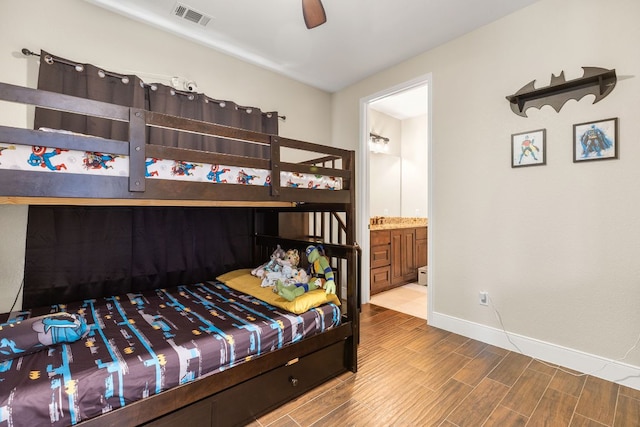 479 Brown Rd, Mcdade, TX 78650 - bedroom featuring wood finished floors, baseboards, and connected bathroom