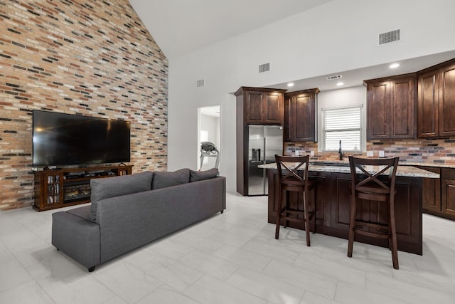 479 Brown Rd, Mcdade, TX 78650 - living room with high vaulted ceiling and light marble finish flooring