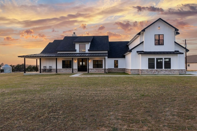 479 Brown Rd, Mcdade, TX 78650 - view of front of house featuring a standing seam roof, board and batten siding, a yard, metal roof, and roof with shingles