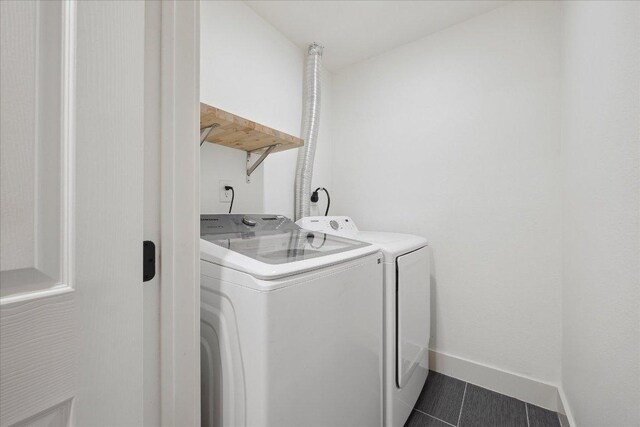 909 Reinli St Unit 231, Austin, TX 78751 - laundry room with separate washer and dryer and dark tile patterned flooring