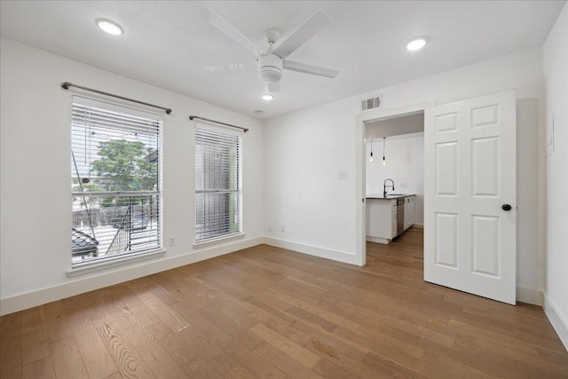 909 Reinli St Unit 231, Austin, TX 78751 - spare room featuring wood finished floors, ceiling fan, and recessed lighting