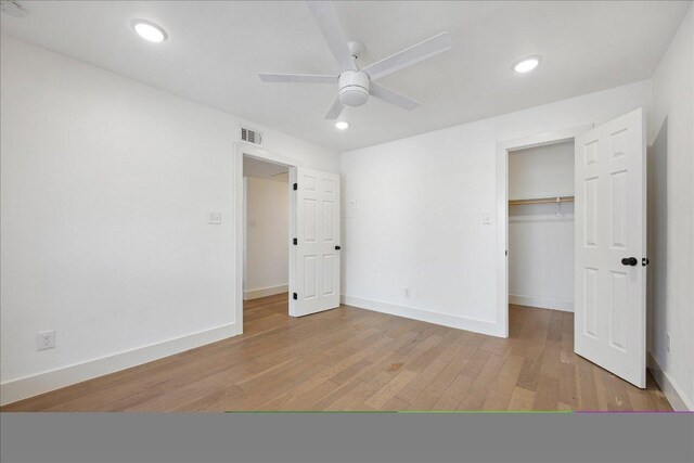 909 Reinli St Unit 231, Austin, TX 78751 - unfurnished bedroom featuring light wood-style floors, a walk in closet, a closet, recessed lighting, and a ceiling fan