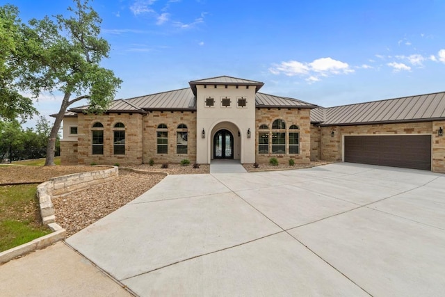 8295 Lime Creek Rd, Volente, TX 78641 - view of front of property featuring a standing seam roof, driveway, metal roof, and an attached garage
