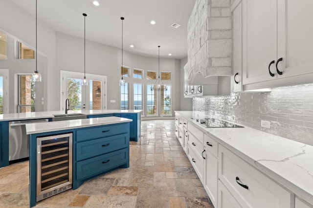 8295 Lime Creek Rd, Volente, TX 78641 - kitchen featuring wine cooler, blue cabinets, dishwasher, a sink, and black electric cooktop