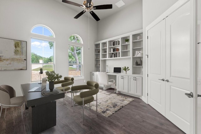 8295 Lime Creek Rd, Volente, TX 78641 - living area with a desk, a ceiling fan, a high ceiling, and dark wood-style floors