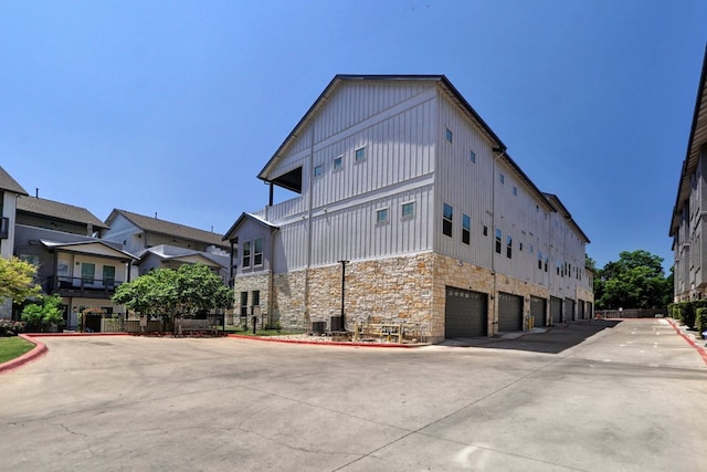 2520 Bluebonnet Ln Unit 41, Austin, TX 78704 - view of building exterior featuring an attached garage and concrete driveway