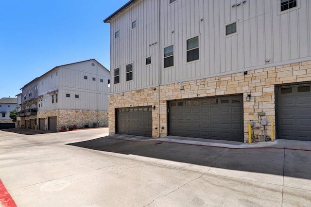 2520 Bluebonnet Ln Unit 41, Austin, TX 78704 - view of home's exterior with board and batten siding, stone siding, and an attached garage